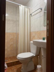 a bathroom with a toilet and a sink at Royal L Hotel in Carev Dvor