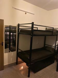 a group of bunk beds in a room at Crossroads Hostel 1980 in Mysore