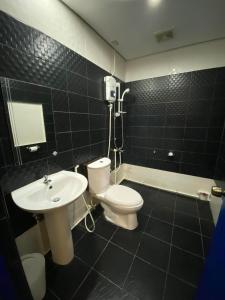 a bathroom with a white toilet and a sink at Lighthouse View Boutique Hotel in Boracay