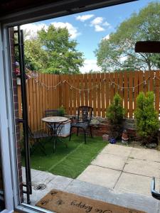a backyard with a wooden fence and a table and a table sidx sidx at Rock Studio -Near City Centre-Free on street Parking-Free Wi-Fi in Leeds