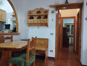 a kitchen with a wooden table and a dining room at Mimosa in Tagliacozzo