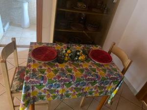 uma mesa com quatro pratos vermelhos em Casa Giola em Solanas