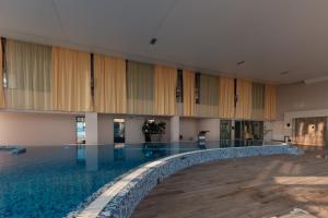 an empty pool in a building with a swimming pool at Eurostars Queen of Montenegro in Budva