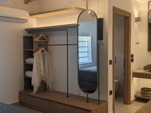 a mirror on a shelf in a bathroom at Panorama Inn in Lithakia +177 photos
