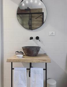 a bathroom with a sink and a mirror at Casa Amapola in Follonica