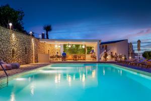 a swimming pool in front of a house at Anasa Corfu in Benitses +70 photos