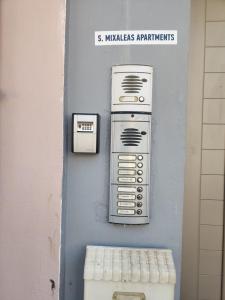 a wall with a machine on the side of a building at Mixaleas apartments in Kalamata