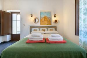 a bedroom with a bed with two pillows on it at Casa El Patio Teseguite in Teseguite