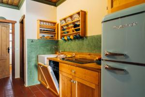 a kitchen with a refrigerator and a counter top at Slow Travel Resort - Kirchleitn in Bad Kleinkirchheim