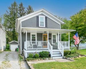 a house with an american flag in front of it at Bell Street by the Falls in Chagrin Falls