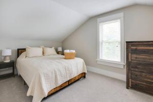 a bedroom with a bed and a window and a dresser at Bell Street by the Falls in Chagrin Falls