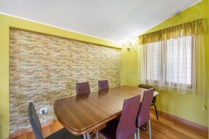 comedor con mesa de madera y sillas en Appartamento Monteleone en Carbonia
