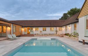 a swimming pool in the backyard of a house at Castle Hill Cottage in Crowborough