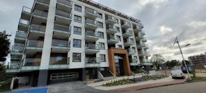an apartment building with a car parked in front of it at Bel Mare Aqua in Międzyzdroje