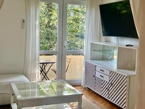 a living room with a tv on a entertainment center at Super Center in Stara Zagora