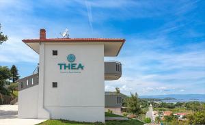 a building with a sign on the side of it at THEA Luxury Apartments in Vourvourou