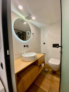 a bathroom with a sink and a toilet at Sunshine Cozy Central Studio Basement in Heraklio