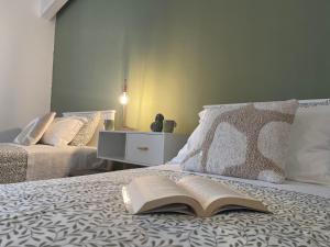 an open book laying on top of a bed at Patruno holidays house in Castellana Grotte
