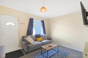 a living room with a couch and a table at Brun Clair House in Chatham