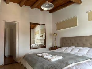 a bedroom with a large bed with towels on it at ApartHosteriaPlaza in La Cumbre