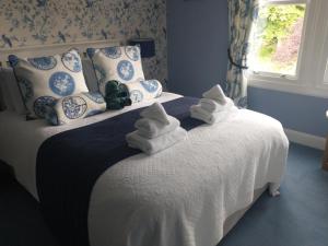 a bedroom with a bed with towels on it at Smiddy House in Spean Bridge