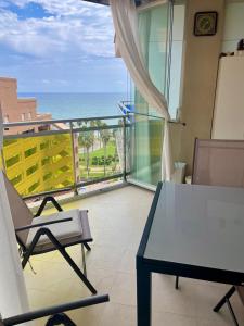 d'un balcon avec une table et des chaises donnant sur l'océan. dans l'établissement Marina Dor Primera Linea, à Oropesa del Mar