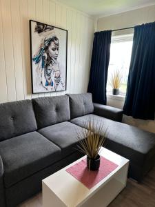 a living room with a couch and a coffee table at Vardø accommodation - white house in Vardø