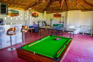 a living room with a pool table in a room at VILLA MIA in Nosy Be