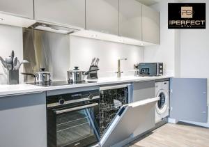a kitchen with a dishwasher and a dish washer at Manhattan Apartment City Centre By Your Perfect Stay short lets Birmingham in Birmingham