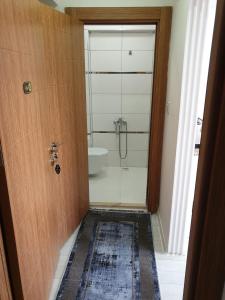 a bathroom with a shower and a toilet and a sink at Sıla Apart Otel in Bostancı