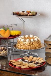 a table topped with plates of food and desserts at Piccolo Orso Bruno in Cavareno