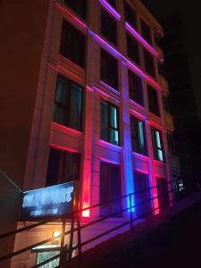 a building with pink and purple lights on it at Sıla Apart Otel in Bostancı