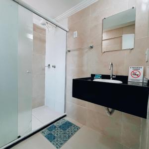 a bathroom with a shower and a sink at Pousada São Jorge in Porto De Galinhas