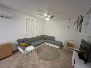 a living room with a couch and a table at Hiška na hribu in Ankaran