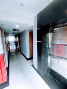 a hallway with a elevator in a building at Studio One Thamrin Hotel in Jakarta
