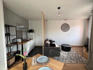 a living room with a couch and a table at Le Marengo in Toulouse