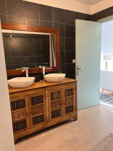 a bathroom with two sinks and a mirror at Le Marengo in Toulouse