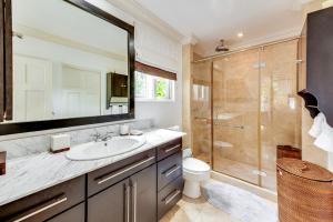 a bathroom with a sink and a shower at The Palms Resort in Saint James