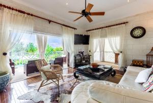 a living room with a couch and a ceiling fan at The Palms Resort in Saint James