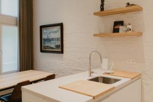 a kitchen with a sink and a counter top at Blue Bird Residence Wijngaard in Antwerp