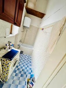 a small bathroom with a sink and a toilet at Apartman Katedrala in Sarajevo