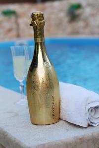 a bottle of champagne sitting on a table with a towel at Estate - Villa Discovery in Ljubuški