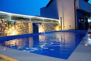 a swimming pool with a fountain in a building at Estate - Villa Discovery in Ljubuški