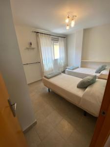 a bedroom with two beds and a window at Palangre Suite en Moraira in Moraira