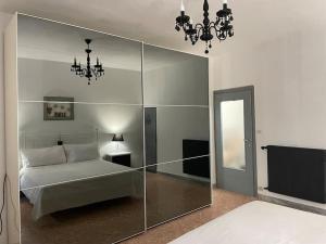 a bedroom with a bed and a glass wall at appartamento velletri centro in Velletri