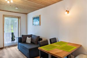 a living room with a table and a couch at Ferienwohnung Lengdobler - Leni in Bad Kohlgrub