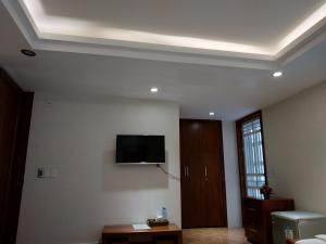 a living room with a flat screen tv on the wall at Minh Đức Green Hotel Tuần Châu in Ha Long