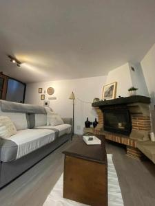 a living room with a couch and a fireplace at Casa parejas La casa de Quintanilla 1 in Quintanilla las Torres