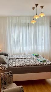 a large bed in a room with a window at Apartmán u lesa, Srní 119 in Srní