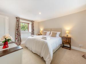 a bedroom with a large white bed and a window at The Wheelhouse in Liverton